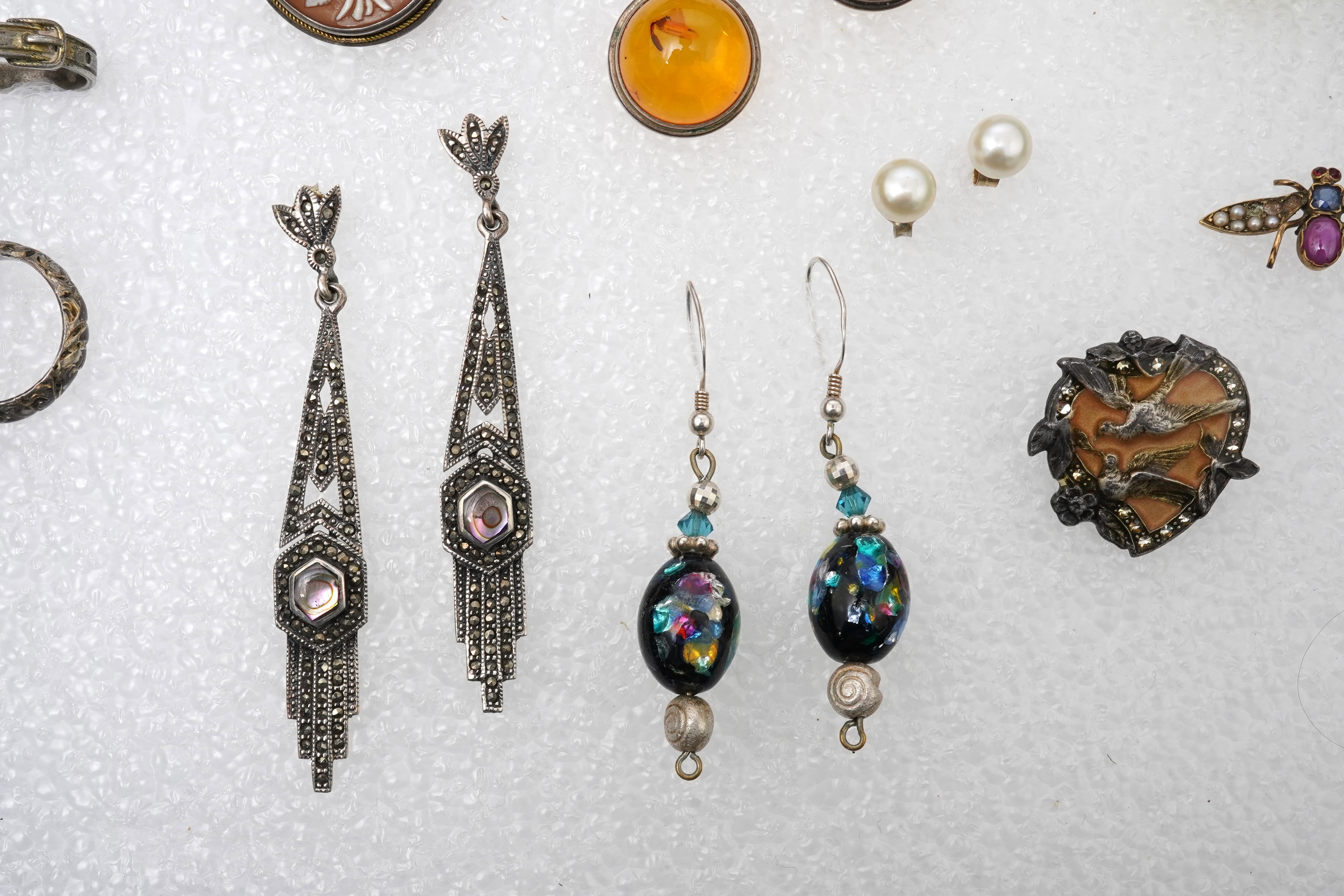 A small collection of costume jewellery to include a silver curb link charm bracelet, hung with assorted bezel set agate and carnelian drops, together with other silver and costume jewellery